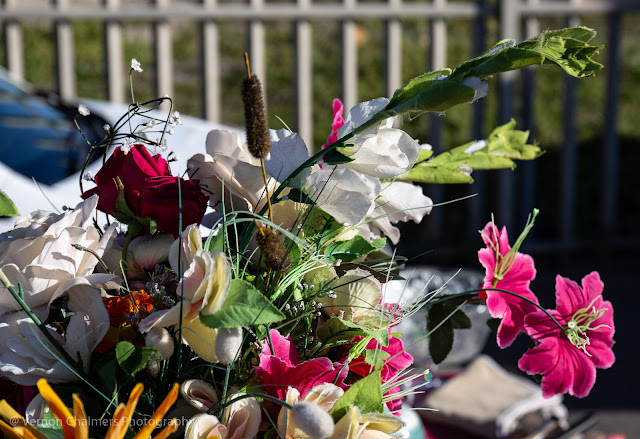 Plastic flowers to decorate and over-loaded table.