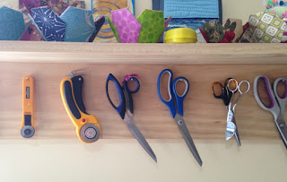 Hooks/nails/pegs keep scissors within reach.