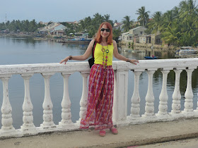 Colourful print gypsy palazzo pants worn with yellow top and bright necklace
