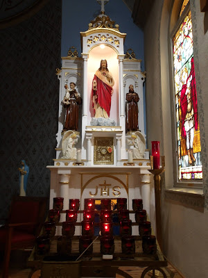 Catholic votive candles and altar in St. Joseph's historic German Catholic Church at Honey Creek, Texas