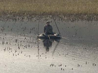 man rides a rubber tire boat