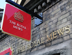 Sign outside Royal Mews at Buckingham Palace, London