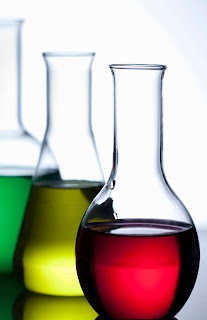 Photo of chemical lab experimental glassware with colorful liquids