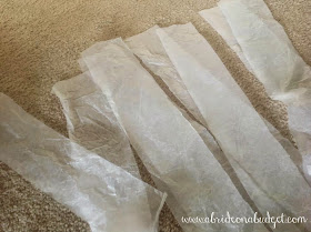 Make a tissue paper tassel garland in minutes without gluing with this tutorial from www.abrideonabudget.com.