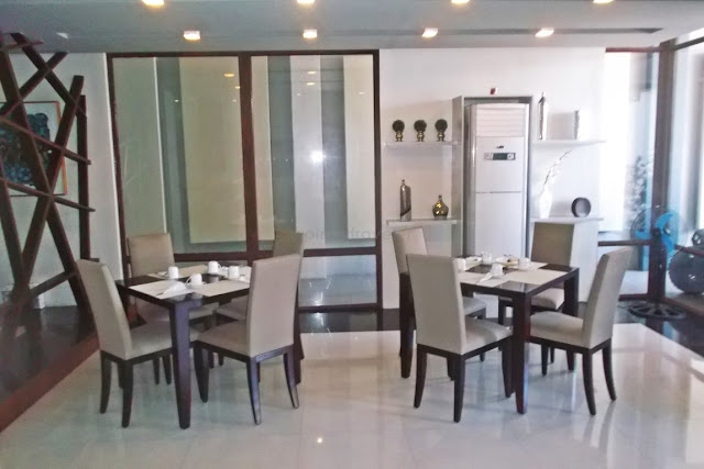 dining tables for four across the lounge area of the lobby at hotel san francisco in catbalogan samar