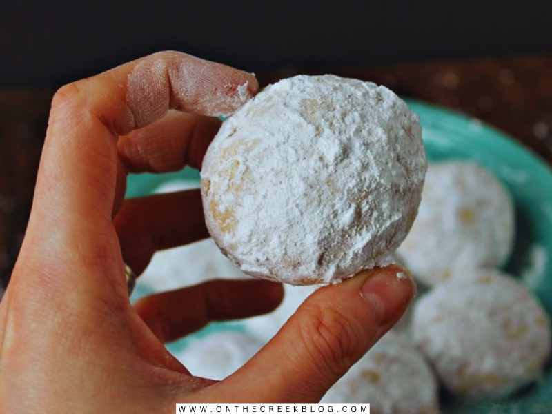 Delicious homemade Snowball Cookies made by Tiff, featuring a dusting of powdered sugar, embodying the festive spirit of Christmas baking. | on the creek blog // www.onthecreekblog.com