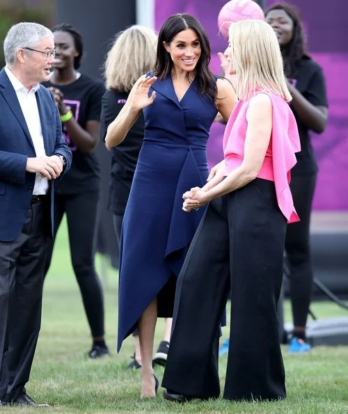 Meghan Markle wore a folded sail dress by Australian fashion designer Dion Lee, Martin Grant coat, Gucci Sylvie bag, Manolo Blahnik suede pumps