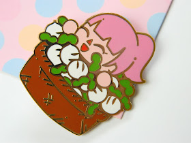 A pin badge of an Animal Crossing girl in a basket of turnips