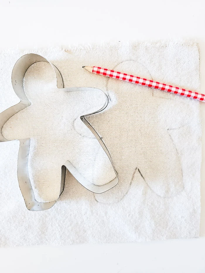 trace cookie cutter onto drop cloth with pencil
