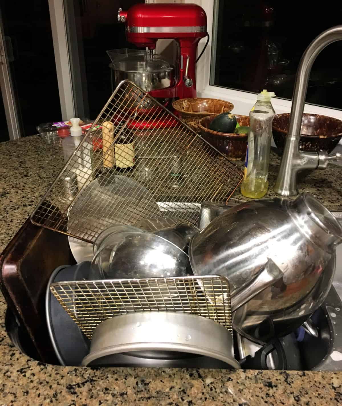 Sink full of cleaned dishes.
