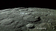 The image shows the lunar surface with numerous craters. Some of these craters are very large, with well-defined edges, while others are smaller and more flattened. The surface also has mountains, valleys and other features.