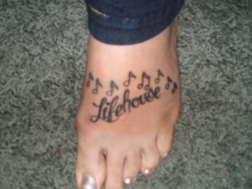 pretty foot tattoos. music notes tattoos on feet