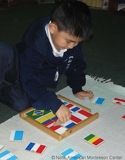 NAMC montessori education reform public schooling obama child with flag puzzle