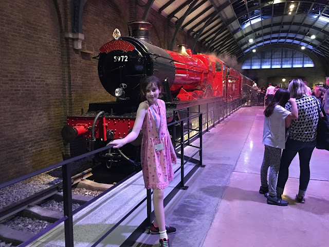 Sasha in front of Hogwarts Express Harry Potter