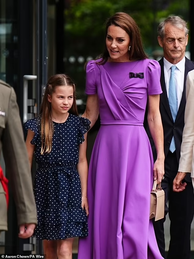 Princess Kate is greeted with a standing ovation as she heads into Royal Box at Wimbledon with Princess Charlotte