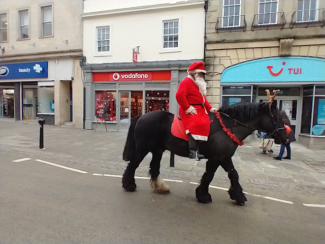 A horse rider dressed as Santa plus his horse disguised as Rudolph