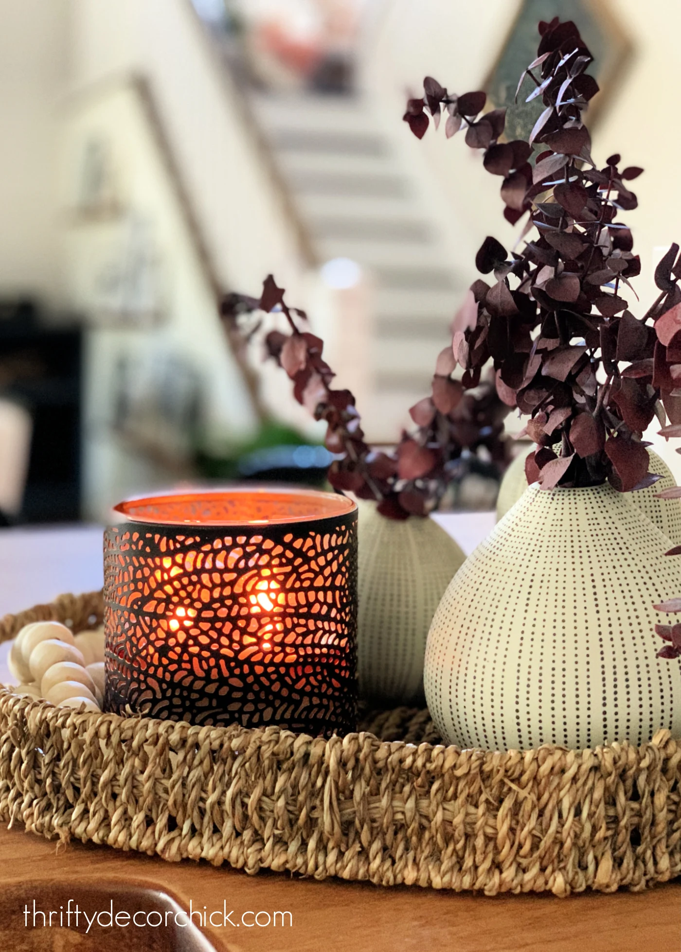 Stone vase, metal candle in rattan basket