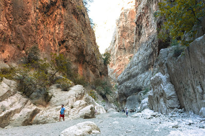Visitors walking inside Saklikent Gorge near Fethiye, surrounded by towering canyon walls, rock formations, and natural beauty
