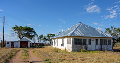 classic eastern New Mexico homestead with square house and outbuilding