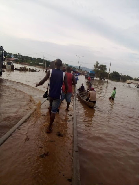 Hundreds Of Motorists, Commuters Stranded As Flood Takes Over Major Roads In Lokoja (Photos)