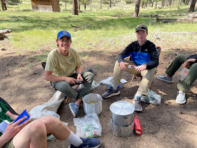 Jake (left) and Rhett prepare an evening meal of rice and summer sausage.