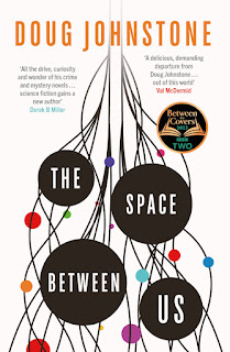 Book "The Space Between Us" by Doug Johnstone. The words of the title are spelled out in block white letters each in a black disk. Between the disks, black lines form a network, converging at the top of the cover into a column leading upwards and fading to grey. Amongst the network are smaller coloured disks - red, orange, blue, purple, cyan.