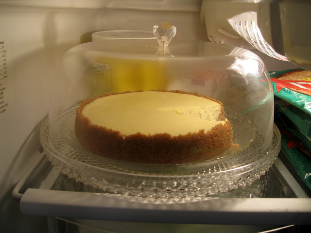 cheesecake in acrylic cake plate in the refrigerator