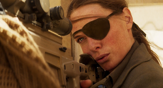 A woman with an eye patch aims a rifle at someone