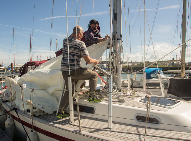 Photo of Phil helping a friend with his sails