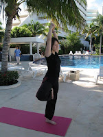 Tanya practicing Yoga beside the hotel pool in tree pose.