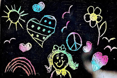 A child's scratch art drawing of a girl, rainbow, sunshine, hearts, and birds.