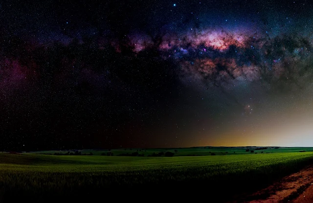 Bring the Beauty of the Night Sky to Your PC with a Panoramic Milky Way Wallpaper Featuring a Wheat Farm in 4K Resolution