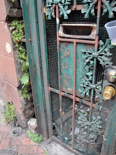 Real leaves in the cracks and the wrought iron leaves on the gate make it leafy.