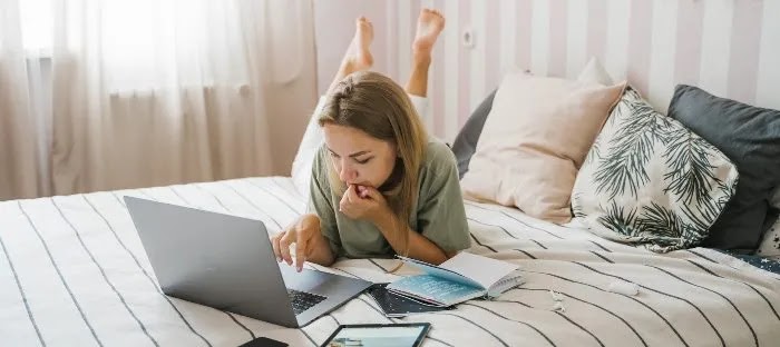 Freelancing offers the opportunity to work comfortably from home, like on a bed. It's a popular reason why many people switch to freelancing.