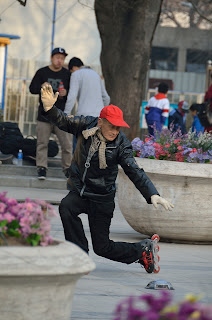 Elderly skater on the plaza and Wangfujing Catholic Church