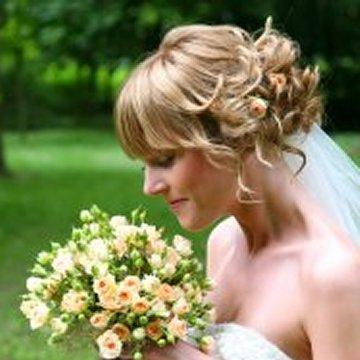 Dramatic allup wedding hairstyle with sideswept bangs