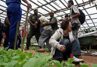 Total disarray: A woman crying as Rela members restrain her husband after they were overcome by emotion when their farm in Kuala Terla was demolished by Cameron Highlands district office enforcement officers yesterday. – Saiful Bahri / The Star