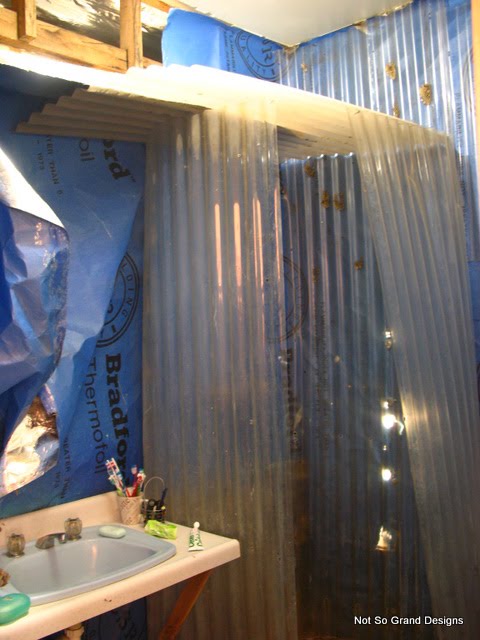  The corrugated plastic shower, vanity-less sink and blue sisalation walls.