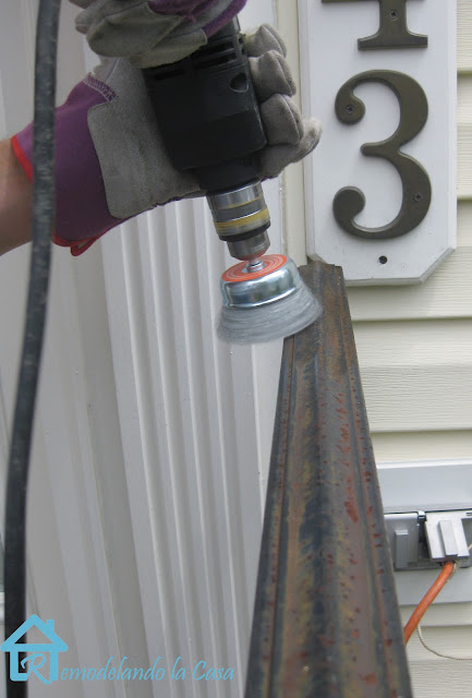 using a wire brush drill attachment to clean railing rust