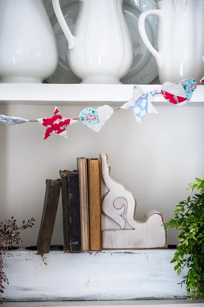 vintage garland hanging on bookshelves