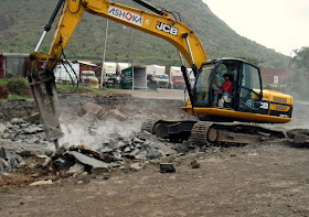 earth mover picking up boulders