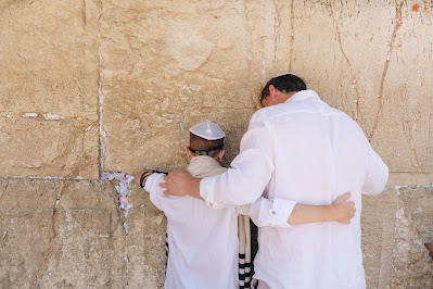 Father and son embracing at the Kotel (Credit: Anton Mislawsky/Unsplash)