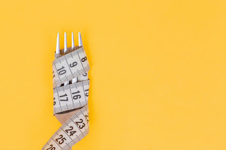 a measuring tape wrapped around a fork