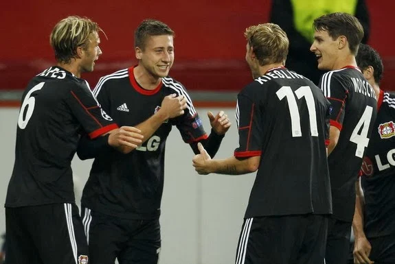 Jens Hegeler is congratulated by Leverkusen teammates after scoring against Real Sociedad