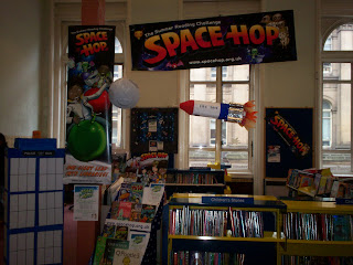 a view of the childrens library at Central. To the left is a replica of the Tardis and a rocket can be seen suspended from the ceiling