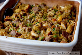 image of a pan with Apple and Sausage Cornbread stuffing and a serving spoon