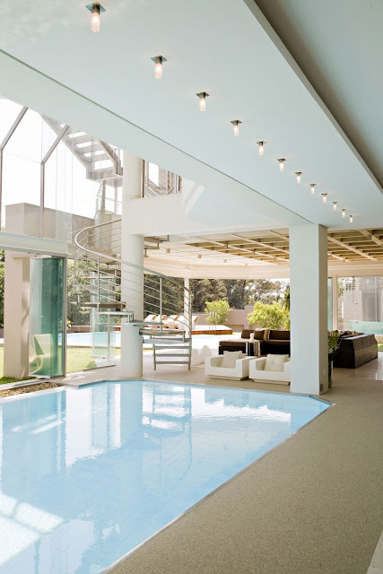 Photo of pool room with spiral staircase and the furniture