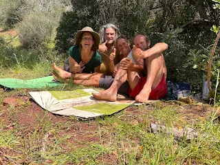 Seve, Oiko, Aim'jie, Meenhard sitting on the isolation mat and carton, laughing.