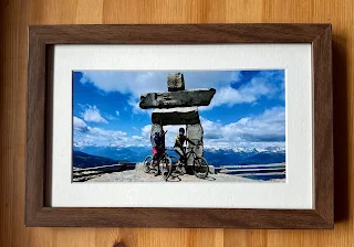 framed photo of two mountain biker at the top of a mountain in canada