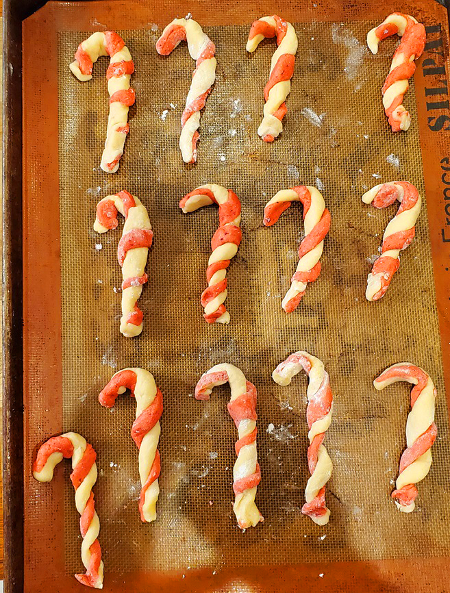 candy cane cookies raw dough twists on a cookie sheet